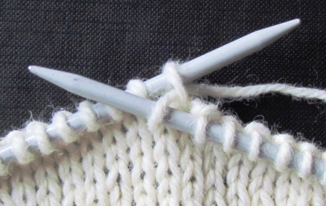 first stage in increasing a stitch when knitting